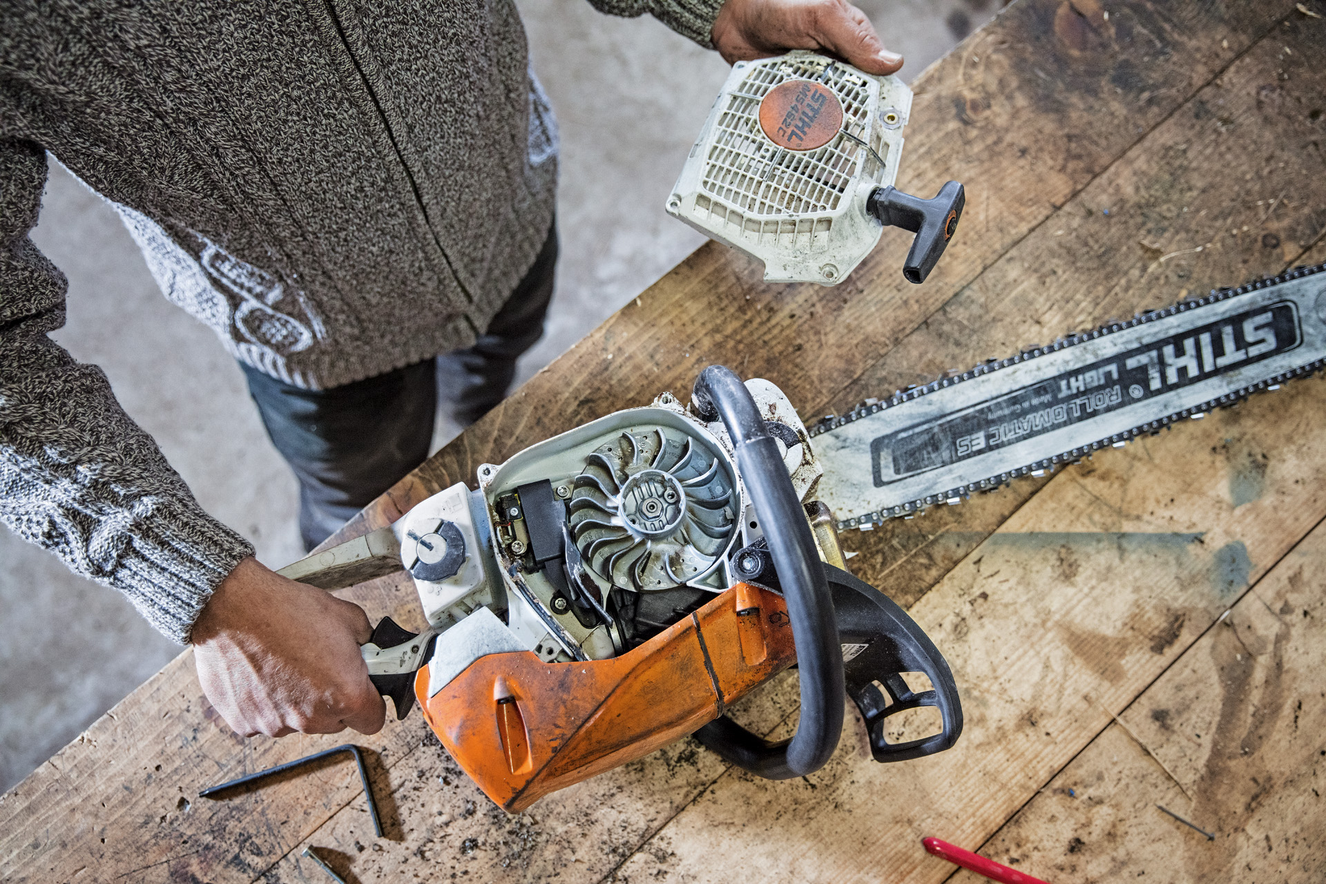 Una motosierra de gasolina STIHL MS 462 C-M en un banco con la tapa del cilindro retirada